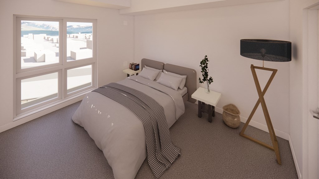 a white bedroom with a bed and a large window