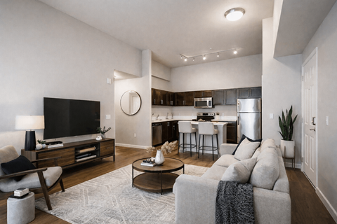 A modern living room with a grey couch and a wooden coffee table.