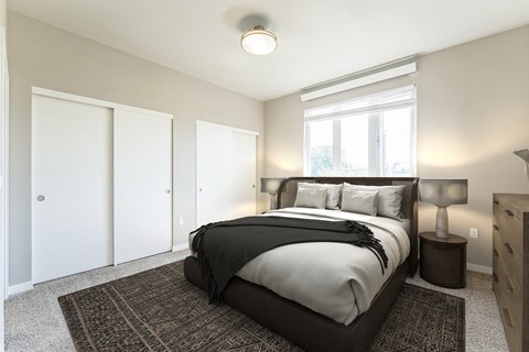 A bedroom with a large bed and a window.
