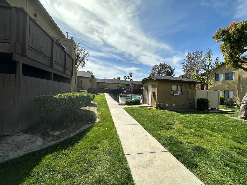 Private patios and balconies along swimming pool courtyard at Riverdale Apartment Homes in Hemet, California.
