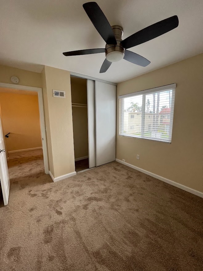 Bedroom with ceiling fan and large closet at 980 E Mission Avenue Apartments.