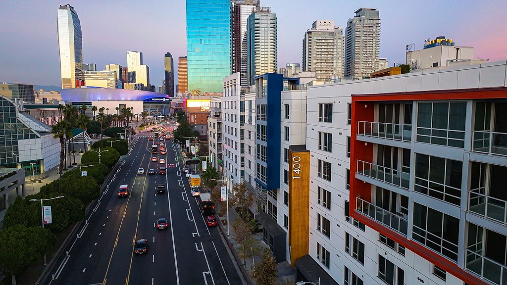 a view of a busy city street with tall buildings