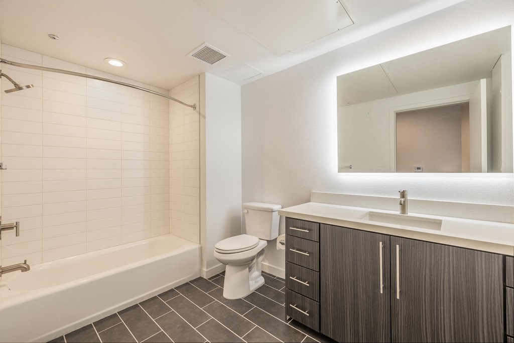 a bathroom with a sink toilet and a bath tub