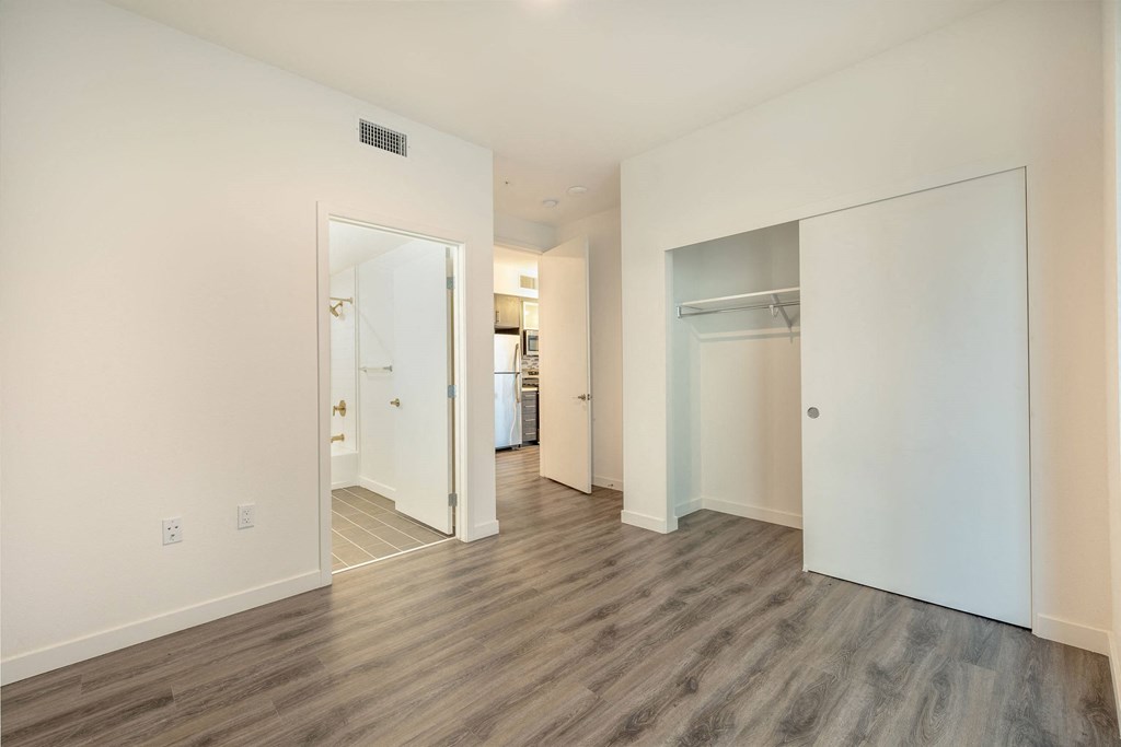 a renovated living room with white walls and wood floors