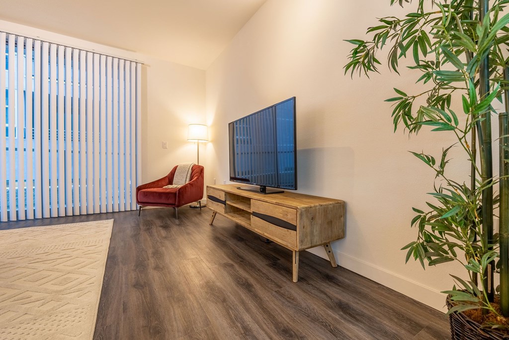 a living room with a couch and a tv on a wooden table