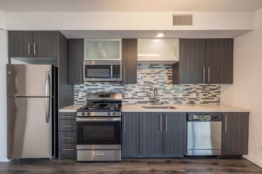 a kitchen with stainless steel appliances and a counter top