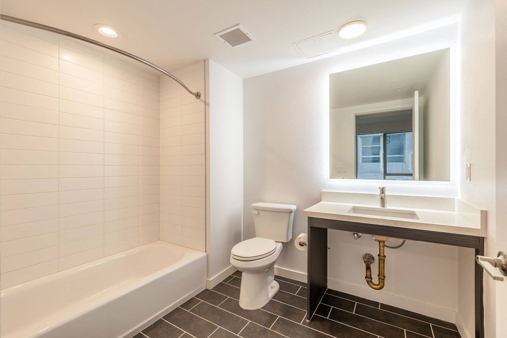 a bathroom with a toilet sink and a bath tub
