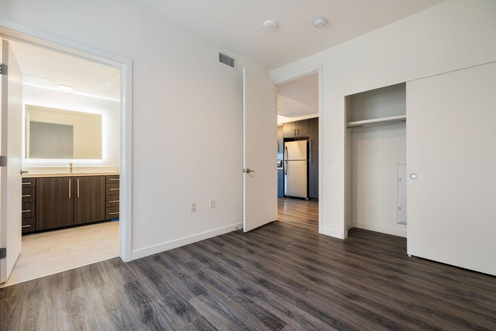 a renovated living room with white walls and wood flooring