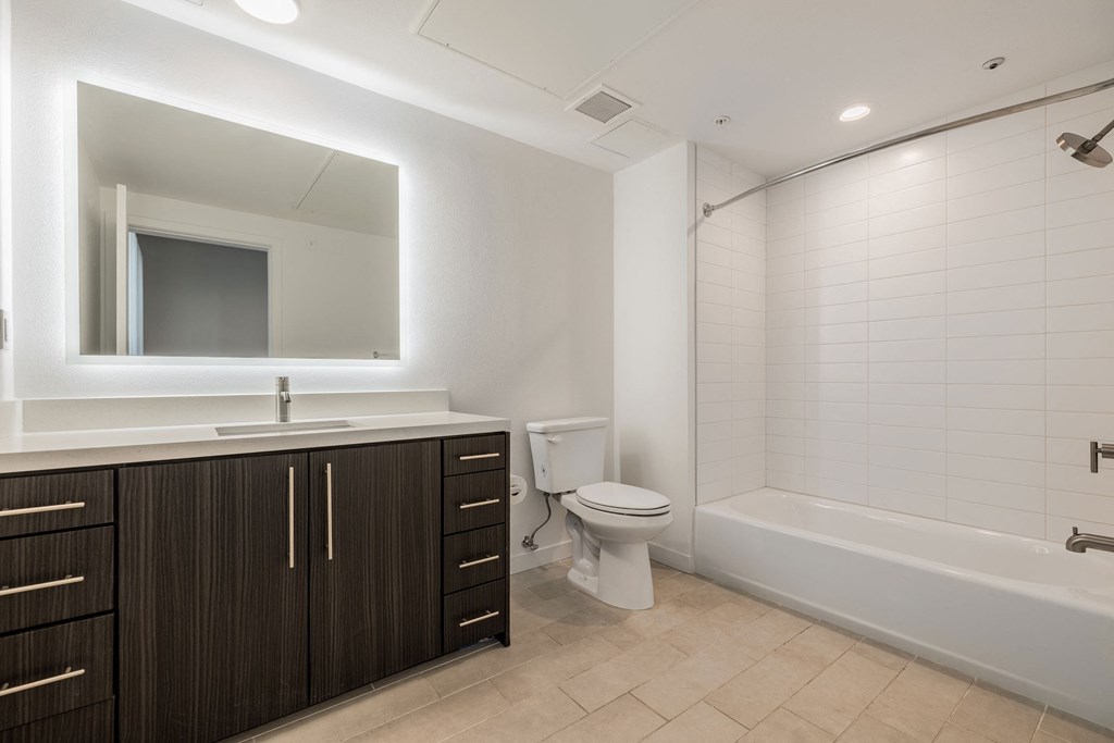 a bathroom with a toilet and a sink and a bath tub