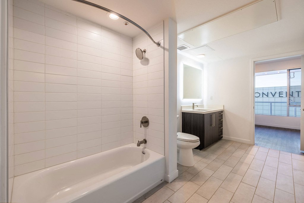 a bathroom with a tub and a toilet and a sink