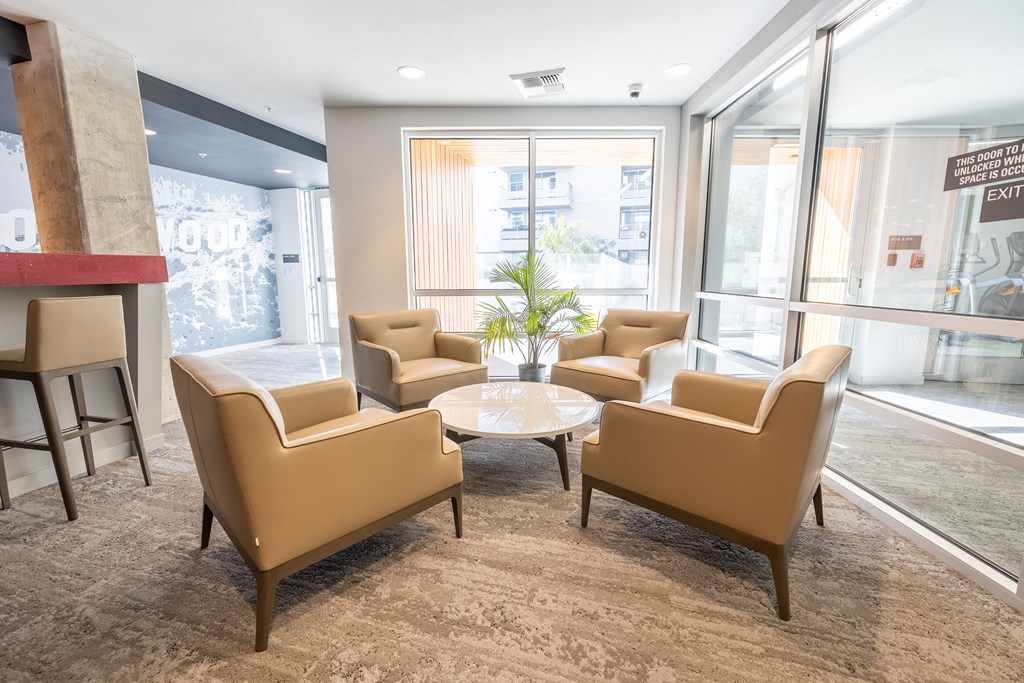 a lounge area with chairs and a coffee table