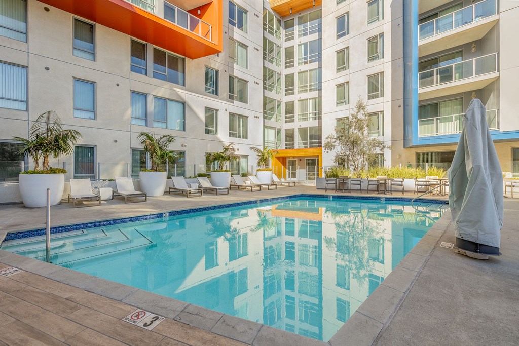 a swimming pool in front of an apartment building