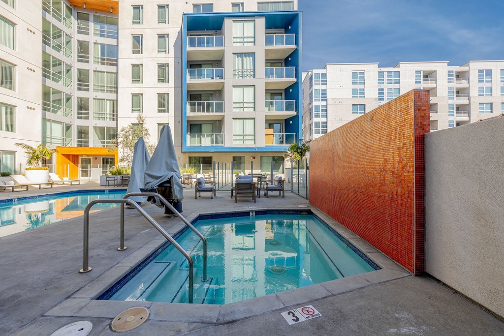 a swimming pool with a building in the background