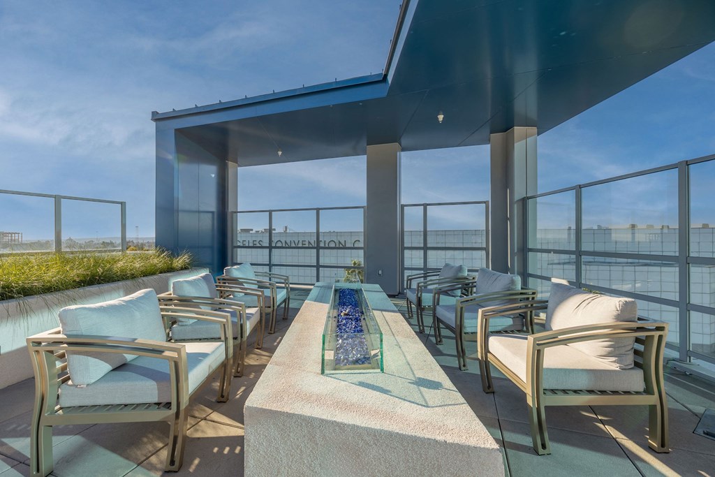 a terrace with chairs and a table overlooking a river