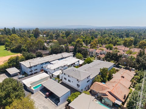 A bird's eye view of a residential area with houses and trees.