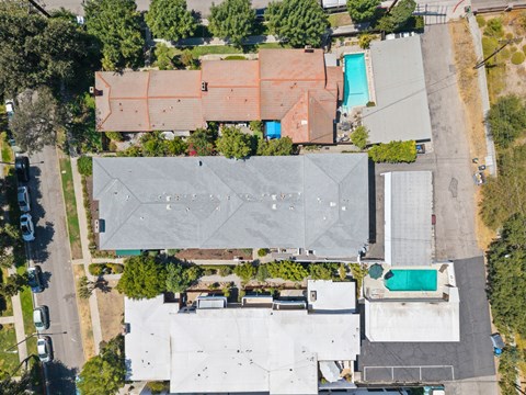 A large grey building with a pool in the middle of it.