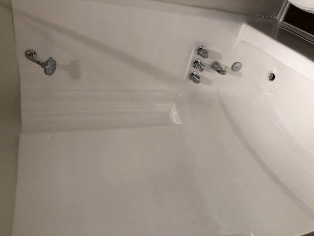 a white bath tub sitting next to a white sink