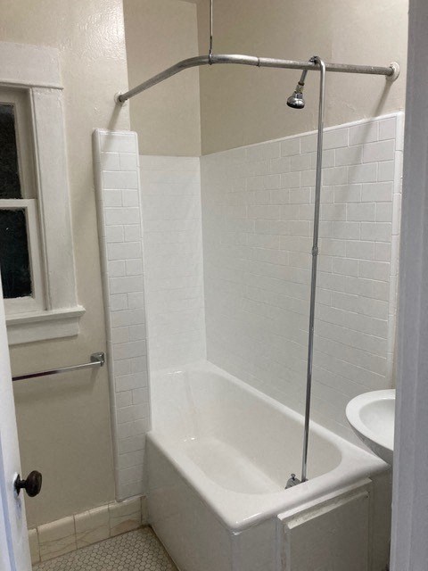 Bathroom with white tile and fixtures at The Western at Rosewood in Los Angeles, California.