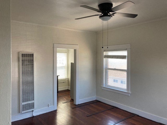 Studio apartment with beautiful hardwood floors, ceiling fan, and great natural light at The Western at Rosewood Apartments in Los Angeles, California.