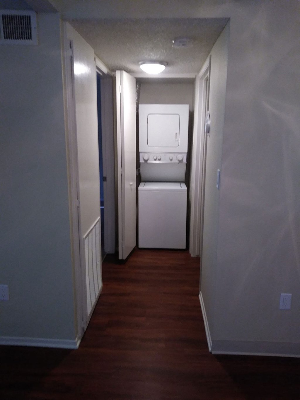 In-unit stacked washer and dryer in apartment at Teton Pines Apartments in Escondido, California.