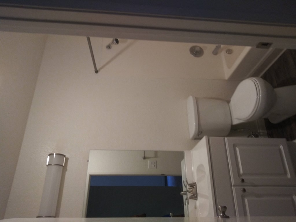 Bathroom with white cabinets at La Costa Seashore Apartments in Carlsbad, CA.