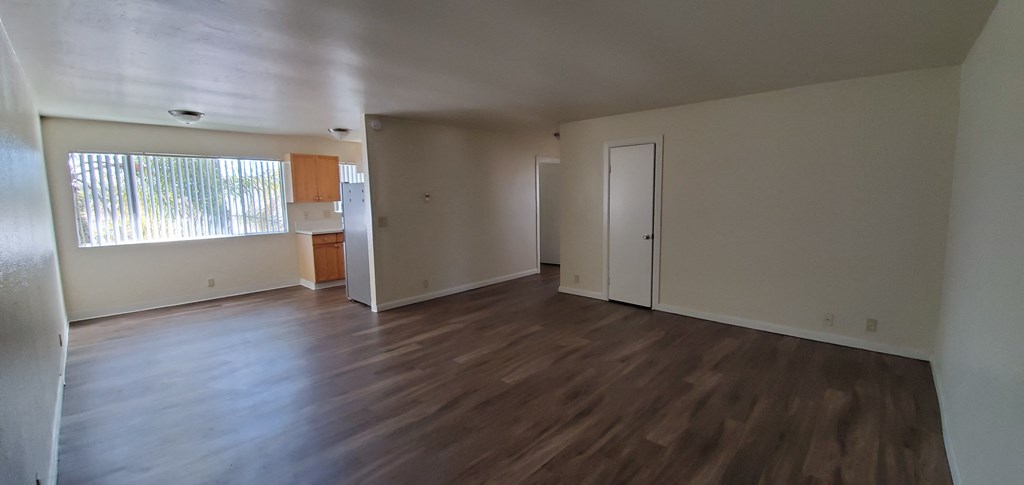 View from front door of living room, dining room and kitchen at Zenith Place Apartments in Chula Vista, California.