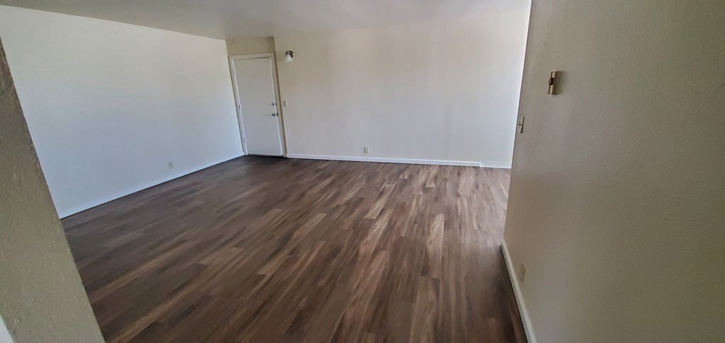 Front room with hardwood flooring at Zenith Place Apartments in Chula Vista, California.
