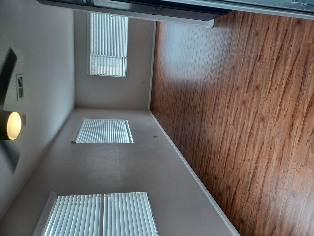 Lots of windows dining area and living room at Juniper Street Apartments in Escondido, California.