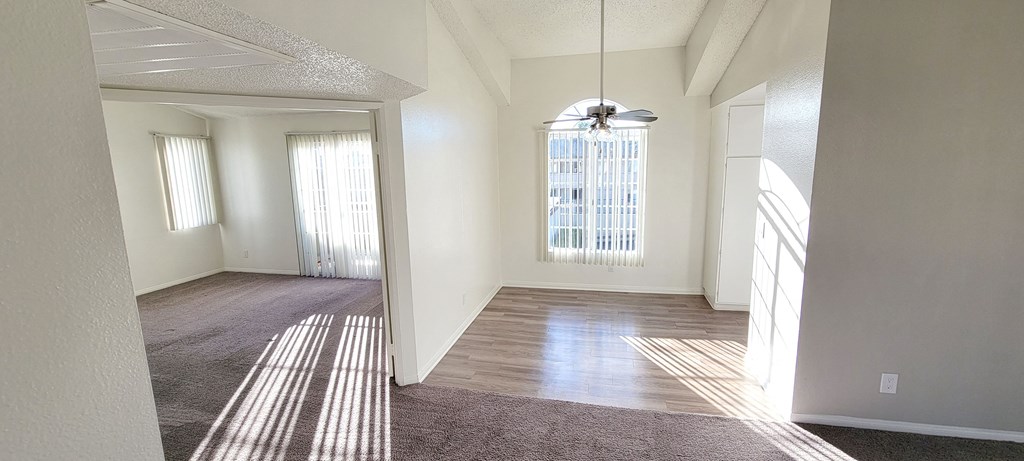Enterance view of one-bedroom apartment with living room, dining room and bedroom at Northwood Apartments in Upland, California.
