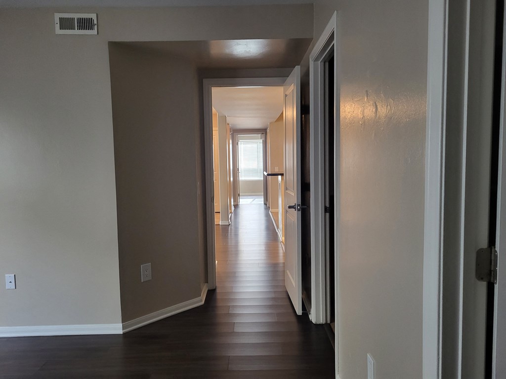 Master bedroom view down hallway to kitchen/living room area and on to bedroom hallway at The Cove at Bear Valley in Escondido, California.