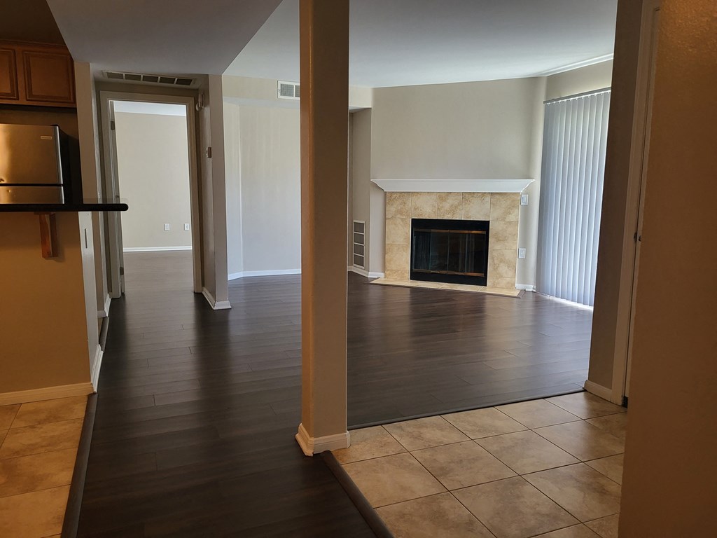 Hallway view back to living room with wood burning fireplace at The Cove at Bear Valley in Escondido, California.