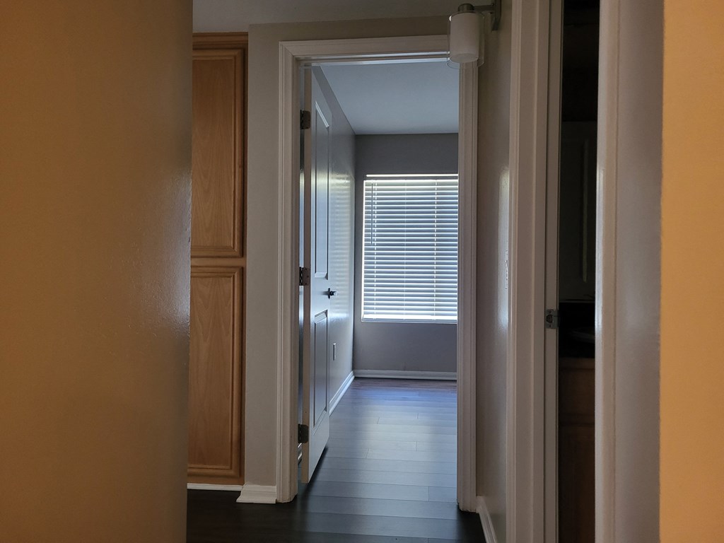 Bedroom hallway with built in cabinets and plank style flooring at The Cove at Bear Valley in Escondido, California.