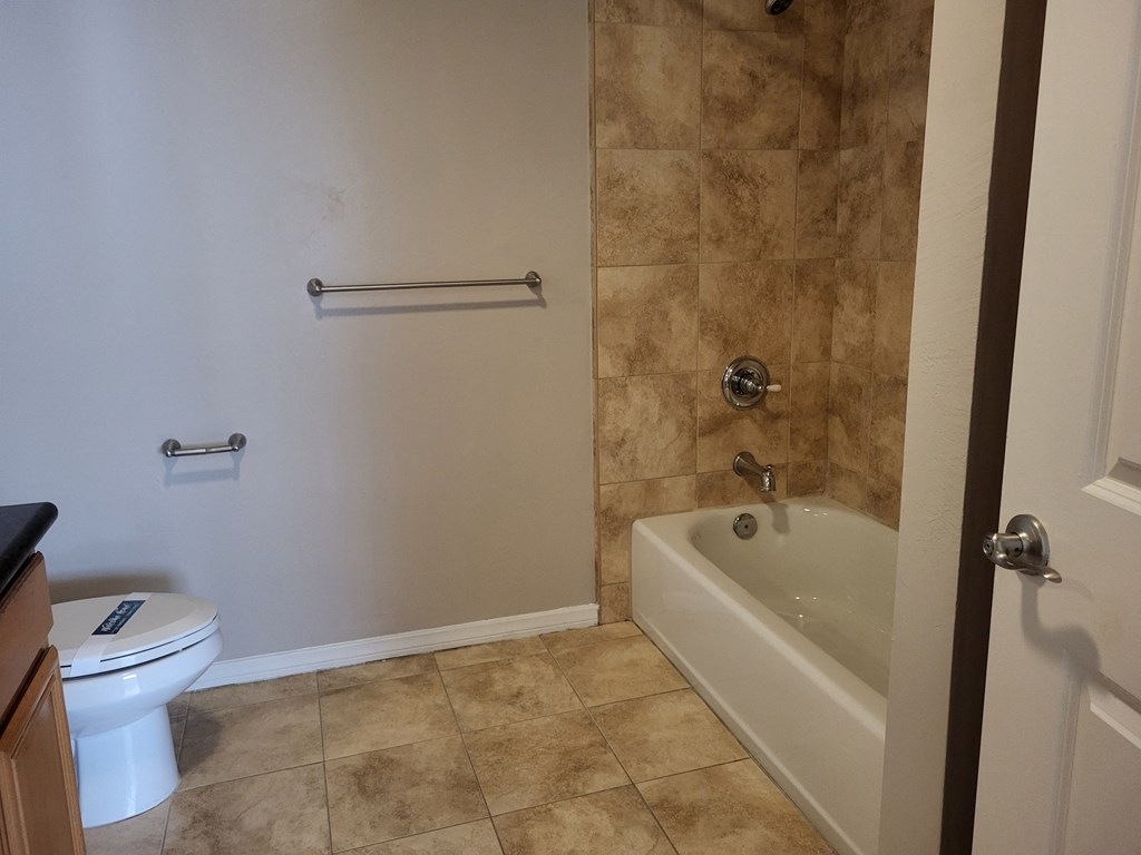 Bathroom with beautiful tiling and white fixtures at The Cove at Bear Valley in Escondido, California.