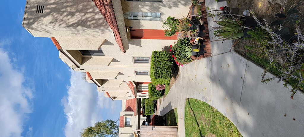 Garden lined apartment walkway at Sierra Vista Apartment Homes in Lake Elsinore, California.