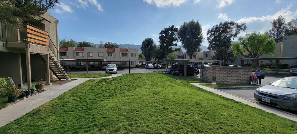 Grass, trees, mountains, and blue sky at Sierra Vista Apartment Homes in Lake Elsinore, California.