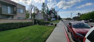 Front gate and landscaping at Sierra Vista Apartment Homes in Lake Elsinore, California.