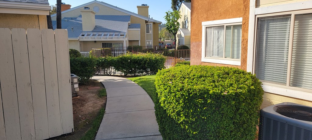 Walkway between buildings around the swimming pool at The Cove at Bear Valley Apartments in Escondido, California.