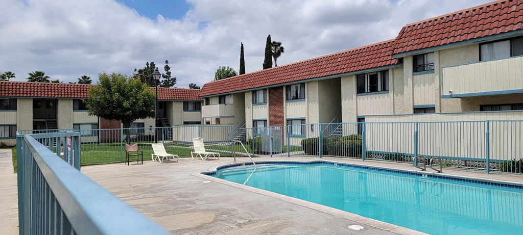 Inviting swimming pool and sun deck at Magnolia Apartments in Riverside, California.