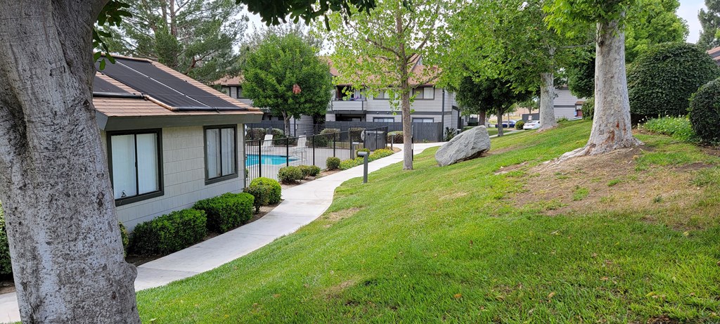 Grassy walkway around office and pool area at Dove Ridge Apartments.