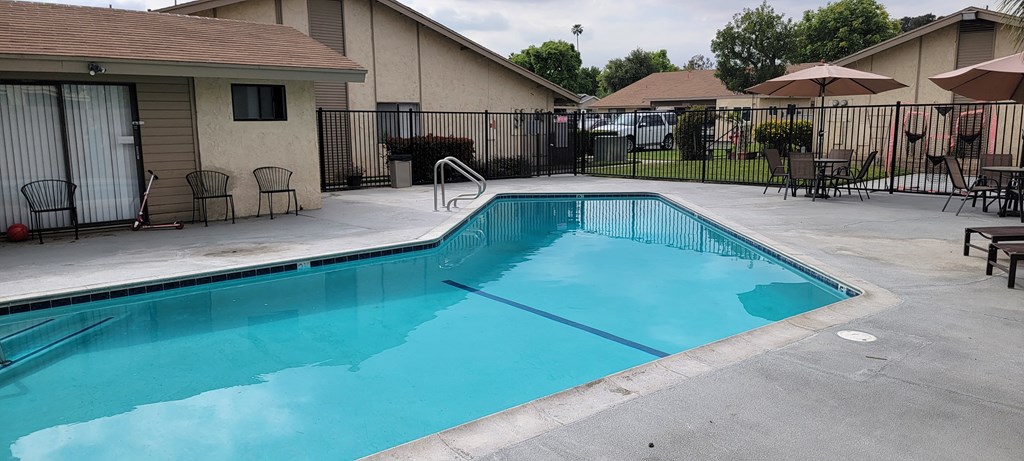 Crystal clear inviting swimming pool at Las Casitas Apartments in Riverside, California.