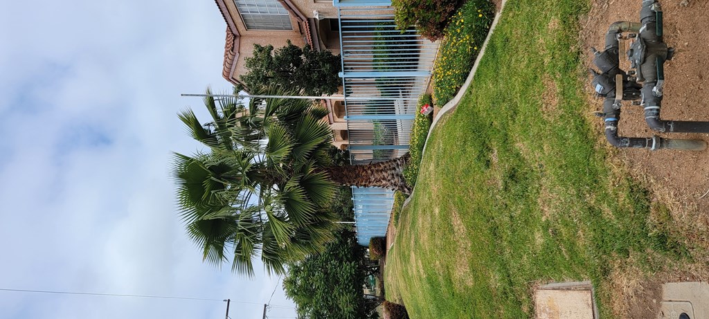 Sidewalk view of front of Palos Verdes Apartments in Moreno Valley, California.