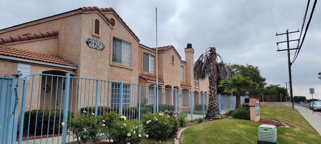 Dracaea Avenue view of front gate area at Palos Verdes Village Townhomes.