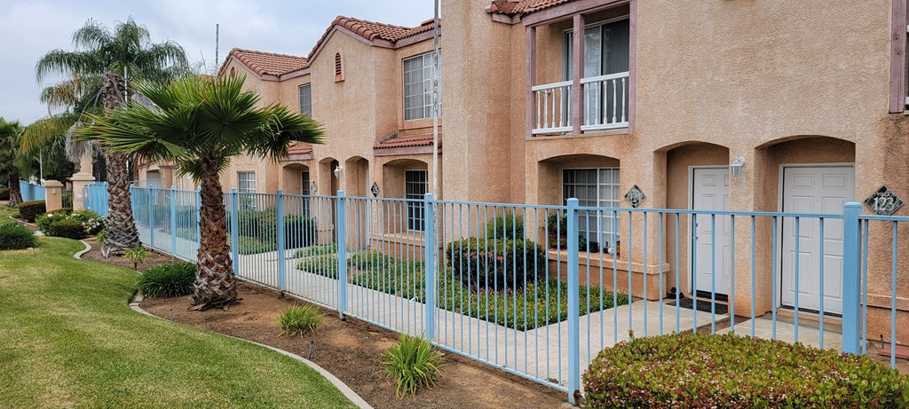 Blue decorative fence along front of Palos Verdes Village Townhomes community.