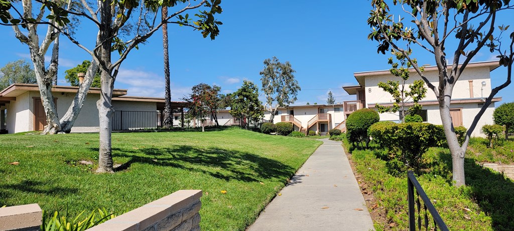 Walkway between apartment buildings at Plaza Verde Apartments in Escondido, California.