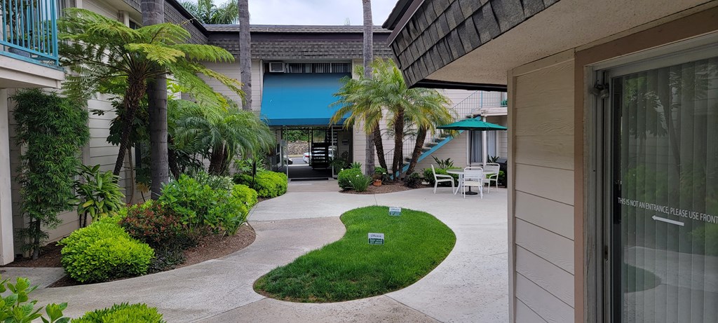 Looking back at courtyard with lush landscaping at La Mesa Village Apartments in La Mesa, California.