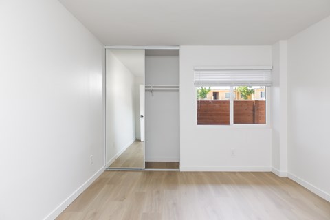 A white room with a sliding door and a window.