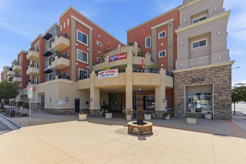 A building with a red and beige facade has a sign that reads "Megastar".