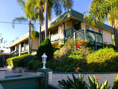Enterance view of lush landscaping aroung Tulip Street Apartments in Escondido, California.