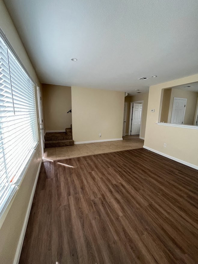 Living room view of front entry and kitchen passthrough at 980 E Mission Avenue Apartments.