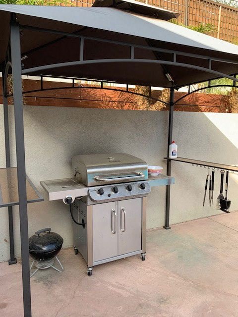 Gas barbeque grill in community area around swimming pool at 5747 Lauretta Street Apartments in San Diego, California.